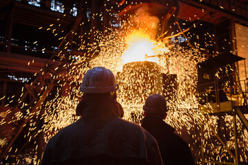 Metallurgists during the process of pouring steel from a ladle.
Ingot casting, metal sparks....