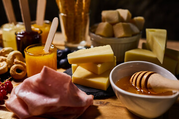 Platter of cold cuts and cheeses with jams and wild fruit