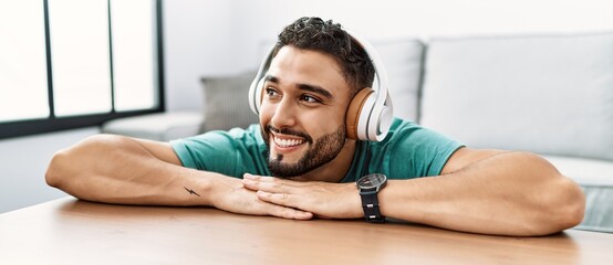 Young arab man smiling confident listening to music at home