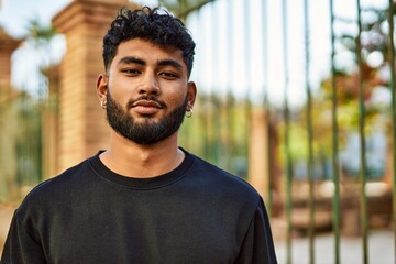 Young arab man smiling confident at street