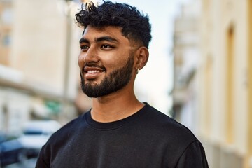 Young arab man smiling confident at street