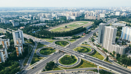 Aerial view of busy urban traffic road with cars and trucks on cityscape view