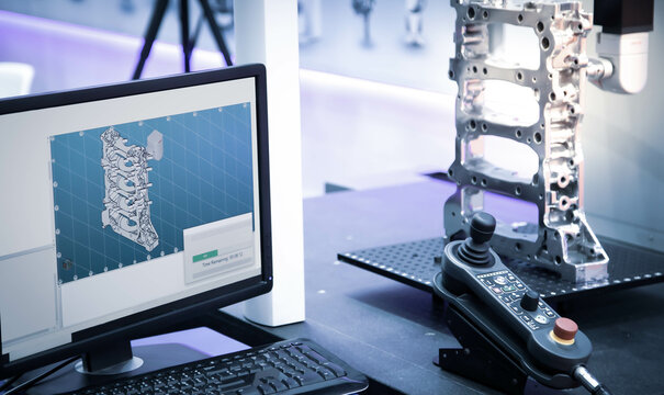 CMM Coordinate Measuring Machine inspecting dimension of automotive engine part.
