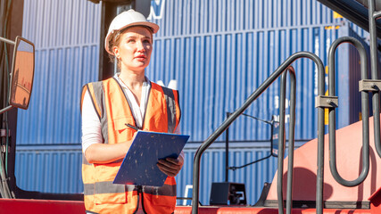 Female Foreman stay on lifting container cargo forklift check or inspect and control forklift concept service and transportation logistic.