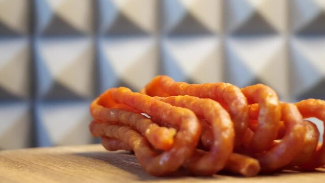 Traditional polish sausages kabanos on a rotating wooden surface. Macro.

