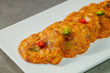 kimchijeon, Korean food kimchi pancake : Slices of well-fermented kimchi mixed into a flour batter and pan- fried. Finely chopped pork, squid, and clam meat may be added to the batter as well.