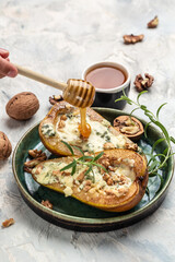 Pears baked with blue cheese, nuts and honey. French cuisine. Keto diet. Vegetarian lunch. banner, menu, recipe place for text, top view