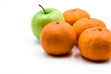 Four clementines and green apple isolated on a white