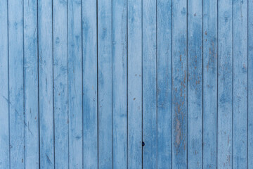 Fototapeta na wymiar old wooden wall with faded blue paint
