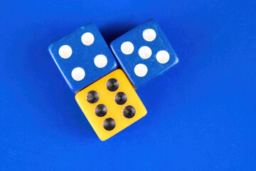 Blue and yellow dice over a solid background