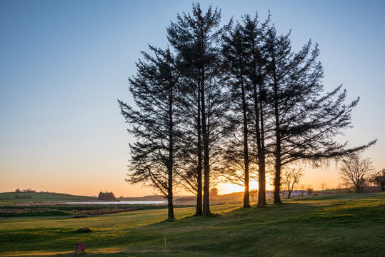 Sunrise over loch anf field clost to Golf Course. 

