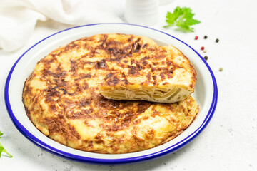 Spanish tortilla on light background. Space for text.