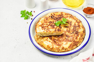 Spanish tortilla on light background. Space for text.