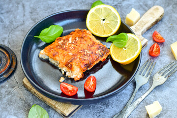Fish bake preparated in Ticino style with sweet gorgonzola cheese and tomato crust