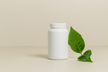 Mockup white medical bottle for pills or vitamins with green leaf, bio supplement, organic...