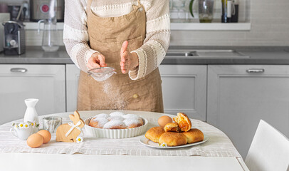 Woman preparing homemade pastry -  buchteln buns, sweet rolls with jam filling. Easter bunny and...