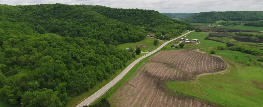 Road Through Rolling Green Hills in Wisconsin Farmland (Drone)