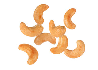 Tasty roasted cashew nuts falling on white background