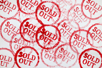 Many red stamps sold out on paper closeup background