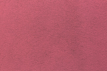 Sample of a texture of pink plaster. Wall finished with a decorative cement stucco. Example of exterior building decoration. Clean uniform grainy background. Banner. Wallpaper. Copy space. Pattern.
