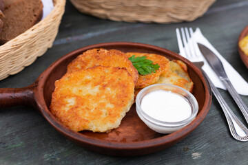 Belarusian cuisine. Potato draniki stew with sour cream