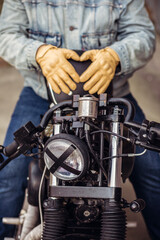 Fototapeta premium Close up set of an attractive driver. Close up motorcycle detail. Black helmet and yellow gloves of a motorcycle driver. Hipster lifestyle. Outdoor concept