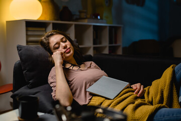 woman fell asleep while reading a book at home