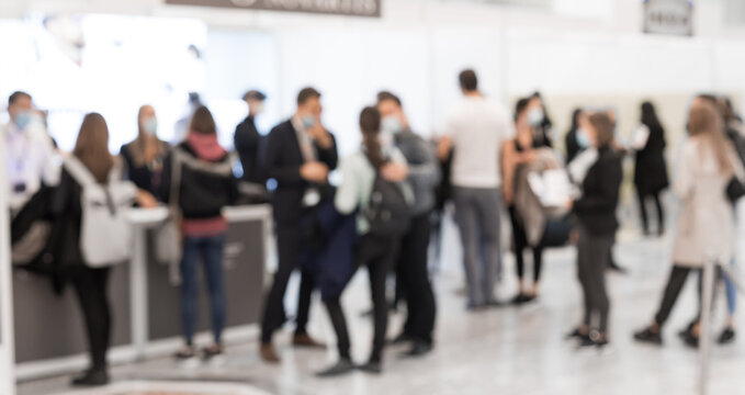 Abstract Blured People At Exhibition Hall Of Expo Event Trade Show. Business Convention Show Or Job Fair. Business Concept Background.