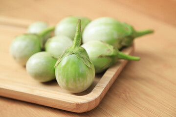 Green organic eggplants on tray for using as a ingredient in healthy eating food