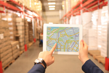 Manager with tablet working at warehouse, closeup. Logistics center