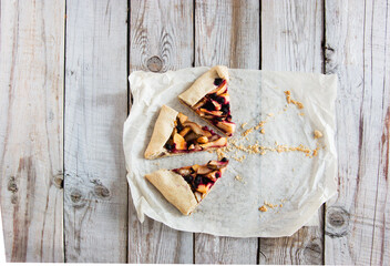 Mixed Apple and Berry Galette on wooden background.