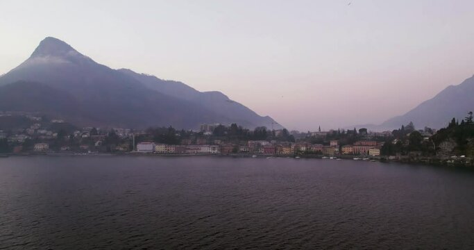 Malgrate city on Lake Como on a foggy winter morning day, aerial shot.
