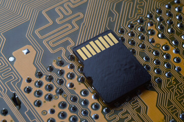 the black micro sd card lies on the microcircuit. close-up.