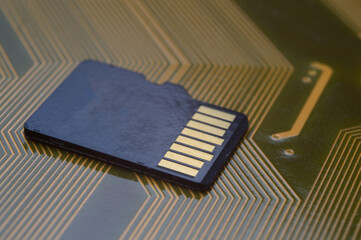 the black micro sd card lies on the microcircuit. close-up.