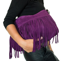 Purple suede bag with fringe in the tanned hands of a girl in black clothes. On a white background