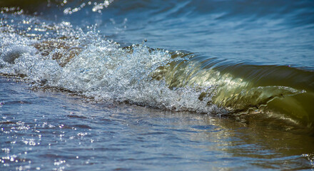 Fototapeta premium Sea wave with spray and foam near the shore