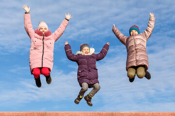 Children jump on sky background. Happy jumping kids. Childhood Happiness. Health and Fitness. Sense...