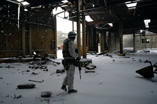 A service member of the Ukrainian armed forces walks at combat positions in Donetsk Region