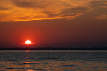 Fototapeta na wymiar Beautiful red and orang sunset over the lake