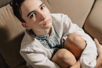 sad young woman of Ukrainian nationality, frightened looks at camera