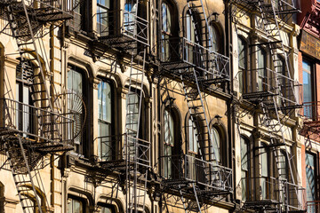 Fototapeta premium Typical Soho loft building facades with fire escapes. Manhattan, New York City