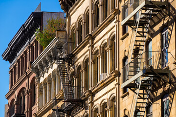 Fototapeta premium Typical Soho loft building facades with fire escapes. Manhattan, New York City