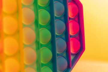 Close up shot of octagon pop it toy on colorful background. Concept