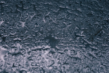 Intriguing Water droplets and Reflections On Top of a Shiny, Reflective, Metallic Surface