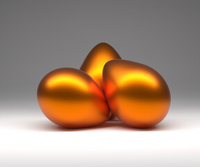 Three golden Easter eggs on a studio background