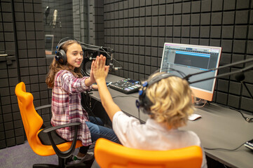 RJs high-fiving each another at the radio station