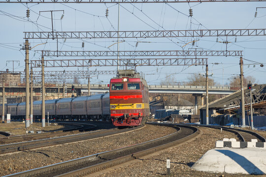 SHARYA, RUSSIA - APRIL 10, 2021: Czech electric locomotive ChS-4t with a passenger train leaves from the Sharya railway station of the Northern Railway
