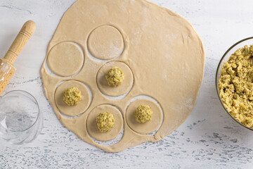 Cooking homemade vegan dumplings, vareniki, pierogi, kreplach  stuffed with vegan lentil 