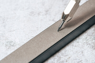 Sharp scraper on diamond whetstone for sharpening. Mechanical cleaning of coins and archaeological...