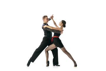 Flexible young couple dancing Argentine tango isolated on white studio background. Artists in black stage costumes - obrazy, fototapety, plakaty